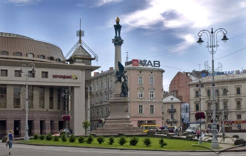 Пам'ятник Міцкевичу. На тлі - будинки на пл. Міцкевича, 10; вул. Валовій, 2; пл. Галицькій, 15